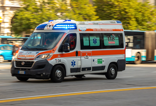 Trieste, Italy. 8 October 2022. Ambulance car speeding in the center of city, blurred motion.