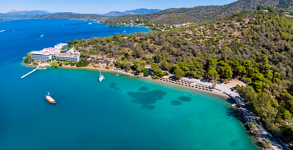 Aerial view of the popular beach Mikro Neorio next to the town of Poros island, Saronic Gulf, Greece