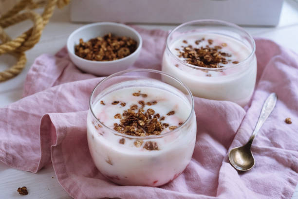 Yogurt with granola and berry jam in glass glasses. A healthy and delicious breakfast. Dairy product. stock photo