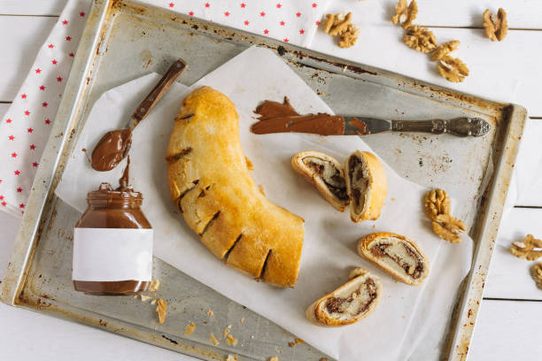 istock Roll with chocolate paste filling and walnuts. Homemade sweet pastries. 1432147977