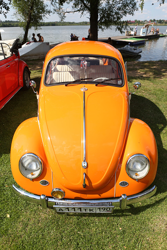 Moscow, Russia - July 23, 2022: Volkswagen Beetle car. Retro orange automobile, vintage car at Tuning Open Fest in Moscow city, Russia