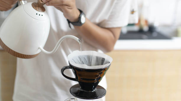 istock Barista is making drip brewing, filtered coffee, or pour over coffee with hot water and filter paper in coffee shop and drip kettle alternatives to coffee shop concept . 1432150948