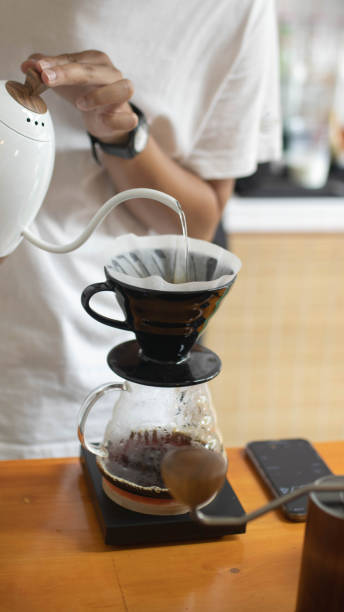 istock Barista is making drip brewing, filtered coffee, or pour over coffee with hot water and filter paper in coffee shop and drip kettle alternatives to coffee shop concept . 1432150950