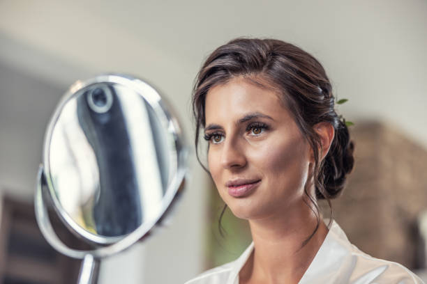 istock Beautiful bride looking into the mirror on her wedding day preparation. 1432151684