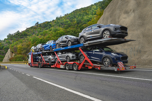 The truck transports new cars produced at the FORD factory in Romania.  Romania, Orsova. October, 07, 2022