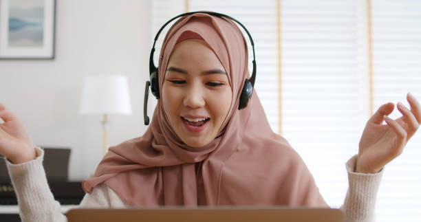 istock Young Gen Z workforce islam woman video call fun talk on webcam laptop work at home office. Asia people arab hijab scarf girl smile study relax remote learn online share job idea on digital webinar. 1432153149