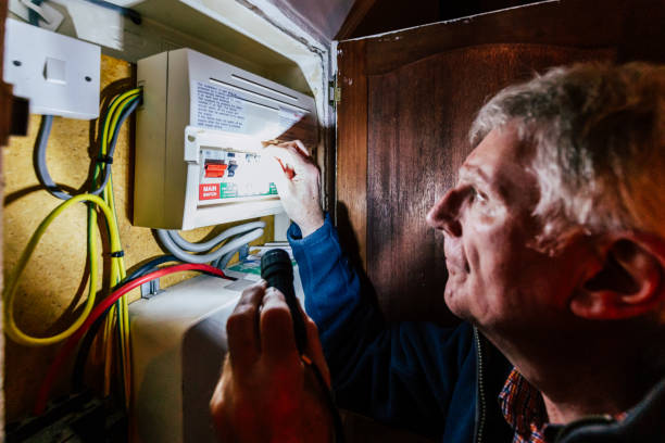 istock Senior man checking home fuse box by torchlight during power outage 1432154073
