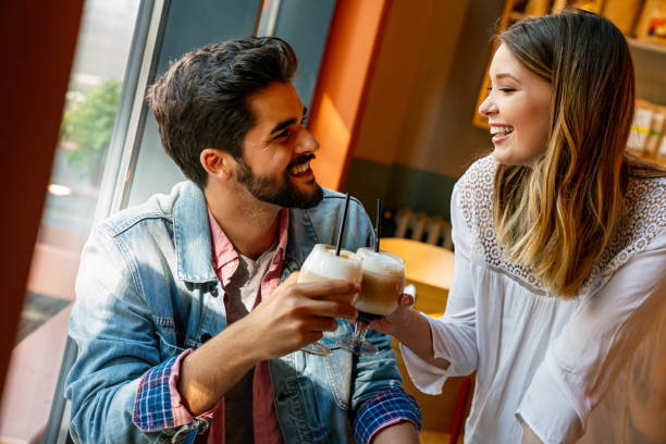 istock Romantic loving couple drinking coffee, having a date in the cafe. 1432155641