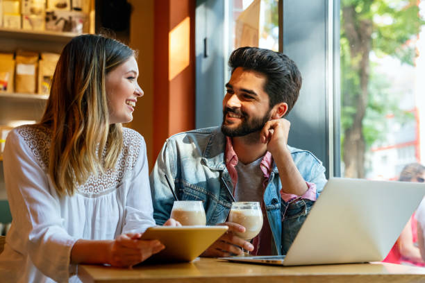 istock Happy couple in love using digital devises for work, study or social media. 1432155662