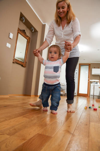 istock Mother teaching her boy to walk 1432155950