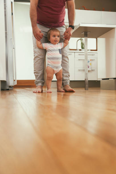 istock Father teaching his boy to walk 1432155959