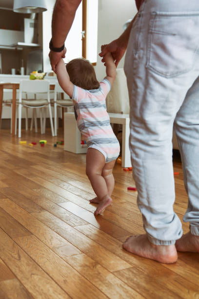 istock Father teaching his boy to walk 1432155968