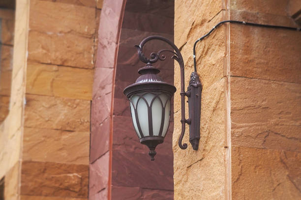 Modern black lamp hanging from the Brown brick wall,It's still closed.