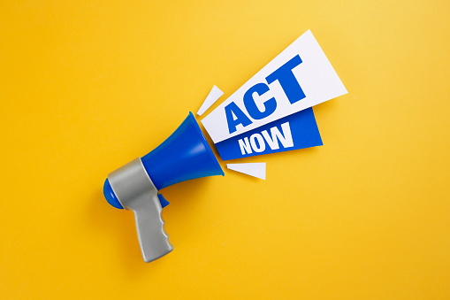 Blue Megaphone with the text Act Now on yellow background