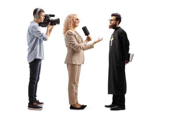Male and female actors giving interview to host at premier. Celebrities interacting with media person. They are at red carpet event.