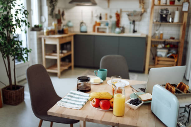 istock Empty cozy apartment with breakfast and laptop on the table 1432158786