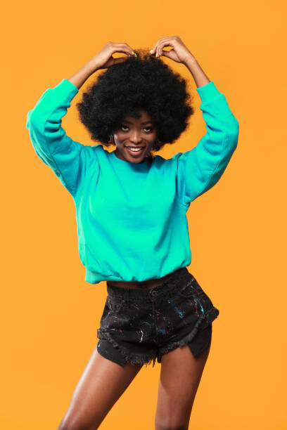 istock Very positive female model with afro hairstyle. 1432160344