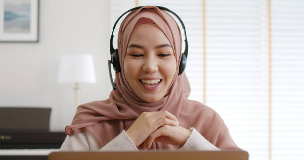 istock Young Gen Z workforce islam woman video call fun talk on webcam laptop work at home office. Asia people arab hijab scarf girl smile study relax remote learn online share job idea on digital webinar. 1432161123