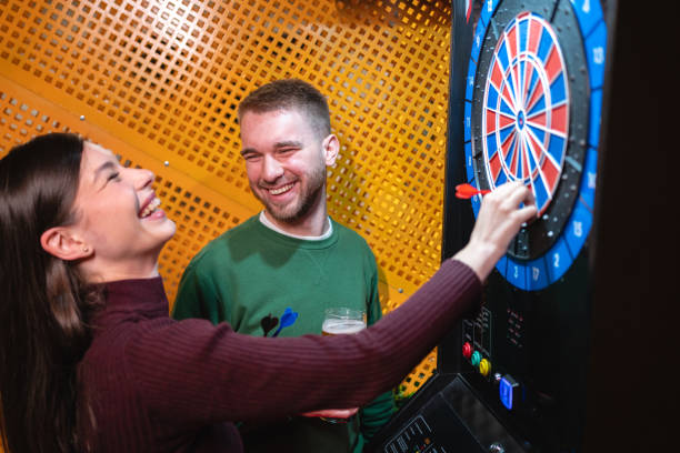 istock Young Caucasian couple playing darts together 1432161580