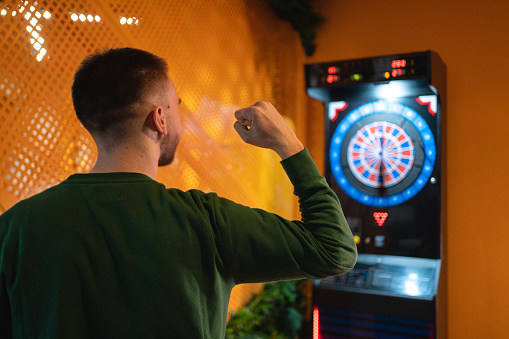 Young attractive couple playing darts