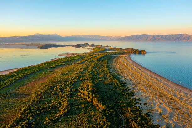 Idyllic view of sea and forest against clear sky during sunset Idyllic view of sea and forest against clear sky during sunset in summer albania stock pictures, royalty-free photos & images