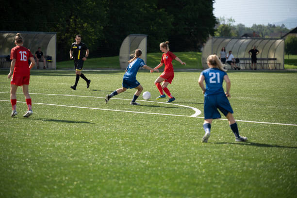 istock Female players kicking ball 1432175626