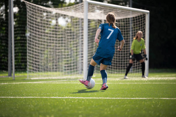istock Female player kicking ball 1432175653