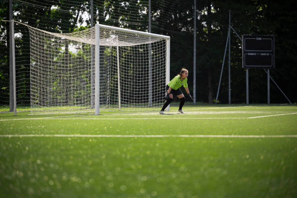 istock Goalkeeper standing near goal post 1432175657