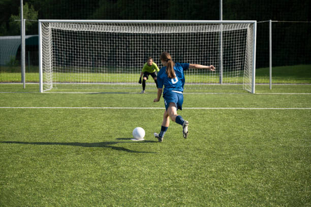 istock Female player kicking ball 1432175659