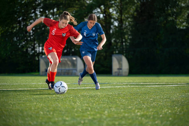 istock Female players kicking ball 1432175696