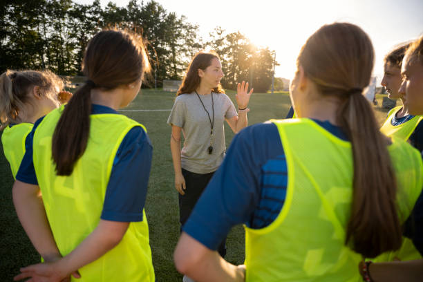 istock Coach instructing to football players 1432175868
