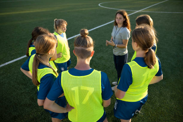 istock Coach instructing to football players 1432175875