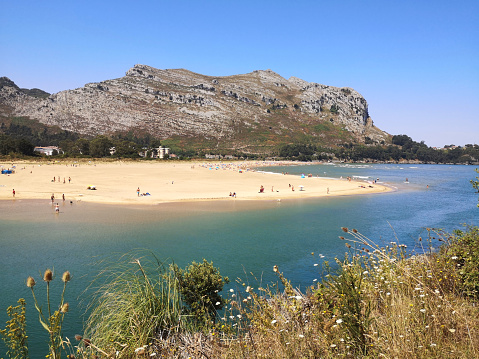 People enjoying sunbathing at Playa De Orinon on the north coast of Spain, Cantabria.