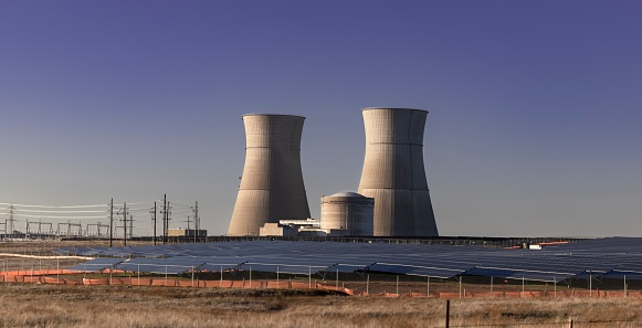 Nuclear power plants next to the solar panels in California against a blue sky