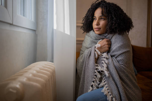 istock Woman feel cold in home with no heating 1432183036