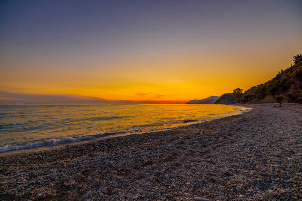 istock Scenic view of waves rushing at sandy beach against sky during sunset 1432183037