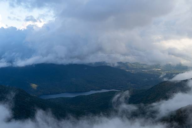 istock Beautiful scenery of a river and hills surrounded by clouds 1432185628