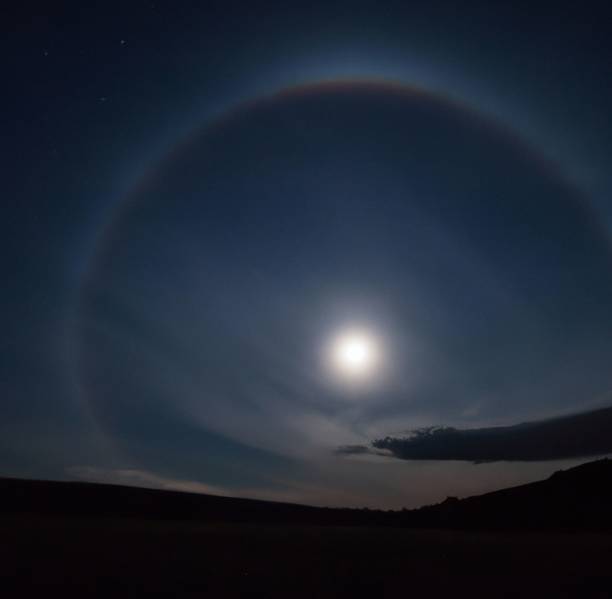 istock Moonbow and a shining full moon  in a clear gray sky 1432185761