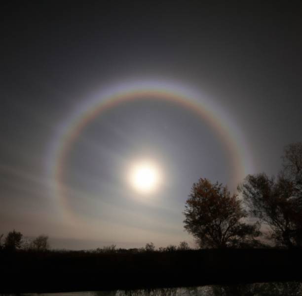 istock Moonbow and a shining full moon  in a clear gray sky 1432185765