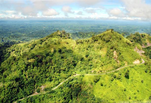 istock Bird's eye view of mountains covered with green forests under a cloudy sky 1432185989