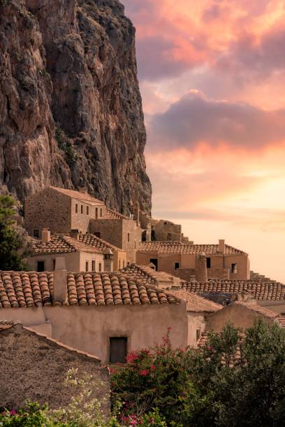 Vertical shot of traditional houses in Monemvasia, Laconia, Greece during sunset A vertical shot of traditional houses in Monemvasia, Laconia, Greece during sunset monemvasia stock pictures, royalty-free photos & images