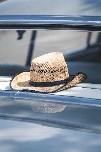 istock Straw hat on the back of a classic American car 1432190882