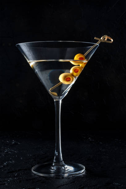istock Martini, a glass with spicy olives on a toothpick, on a black background 1432191022