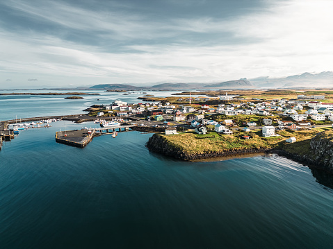 Stykkishólmur is a town situated in the western part of Iceland, in the northern part of the Snaefellsnes peninsula. It is known for its red lighthouse and the fishing harbor.\nAerial view on a calm day.