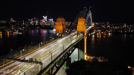 A drone shot of the Sydney Harbour Bridge at night, Australia