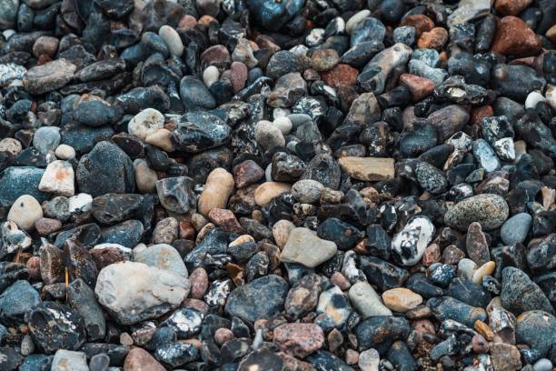 istock Closeup of various colorful pebbles on the beach 1432194120