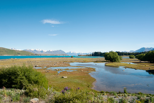 Morning light falls on the landscape around Lake Tekapo on New Zealand's South Island.