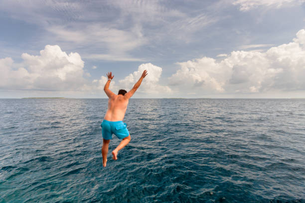 istock Man Jumping Into The Indian Ocean 1432194294