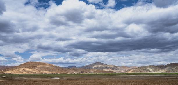 istock Beautiful shot of fields and mountains under a cloudy sky 1432195380