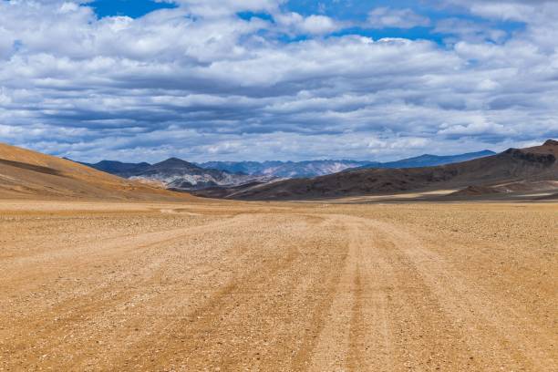 istock Beautiful shot of fields and mountains under a cloudy sky 1432195382